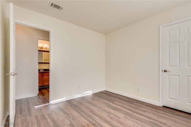 empty room with sink and wood-type flooring