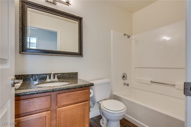 full bathroom with hardwood / wood-style floors, vanity, toilet, and shower / bath combination