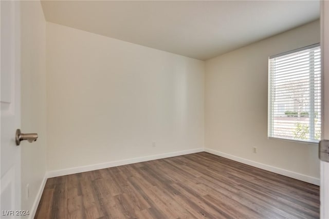 spare room featuring dark hardwood / wood-style floors