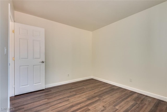 unfurnished room featuring dark hardwood / wood-style floors