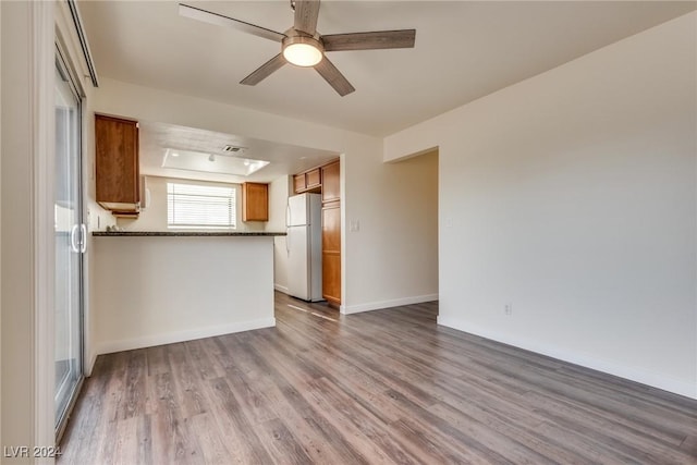 unfurnished living room with ceiling fan and light hardwood / wood-style floors