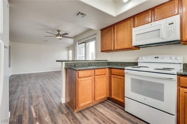 kitchen featuring kitchen peninsula, wood-type flooring, white appliances, and ceiling fan