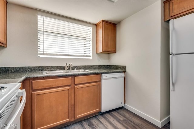 kitchen with white appliances, dark wood-type flooring, and sink