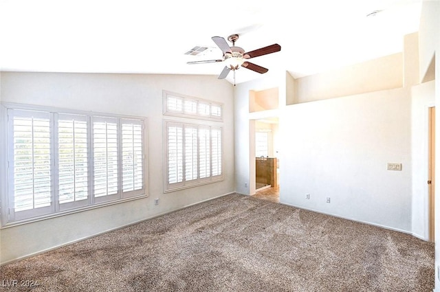 carpeted empty room with ceiling fan and vaulted ceiling