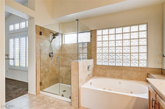 bathroom with tile patterned floors, vanity, and shower with separate bathtub