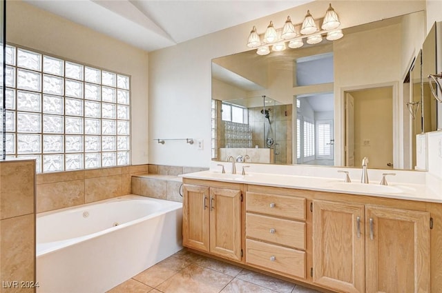 bathroom featuring tile patterned flooring, vaulted ceiling, independent shower and bath, and vanity