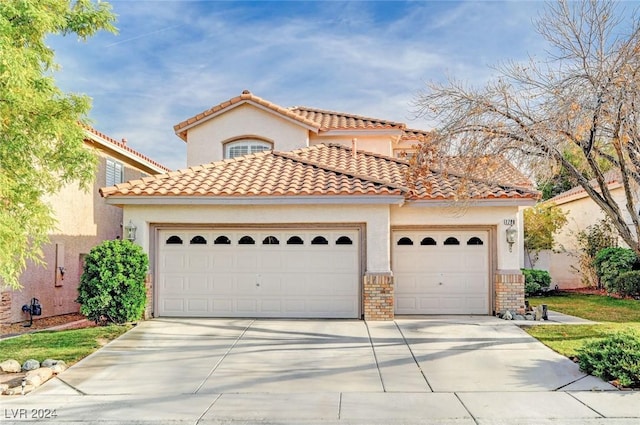 mediterranean / spanish house featuring a garage