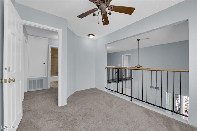 carpeted empty room with ceiling fan