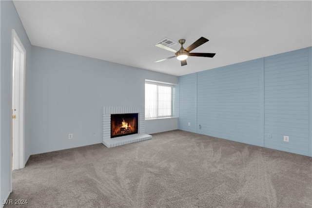 unfurnished living room with light carpet, ceiling fan, and a fireplace