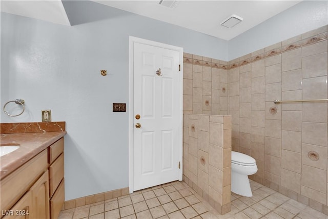 bathroom featuring tile patterned flooring, vanity, and toilet