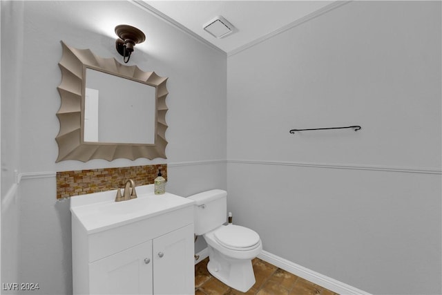 bathroom featuring decorative backsplash, vanity, toilet, and crown molding