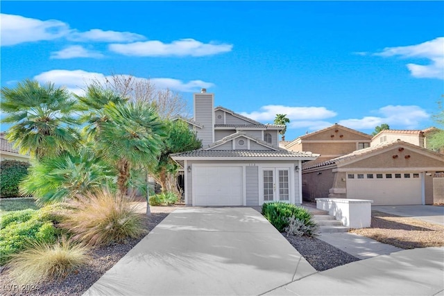 view of front of property featuring a garage and french doors