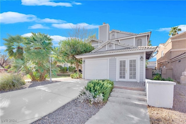 view of front of property featuring french doors and a garage