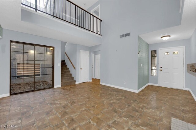 foyer featuring a towering ceiling