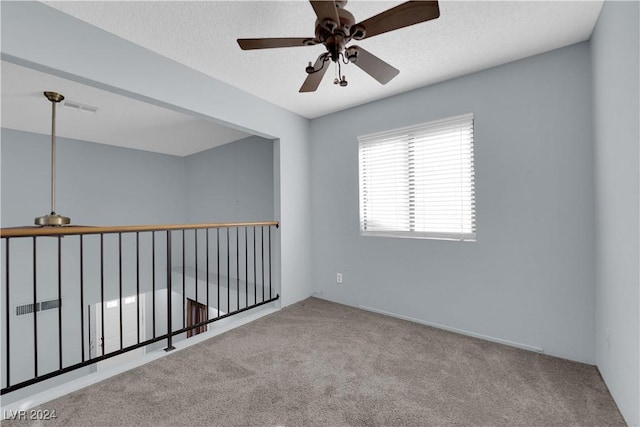 unfurnished room featuring light carpet and ceiling fan