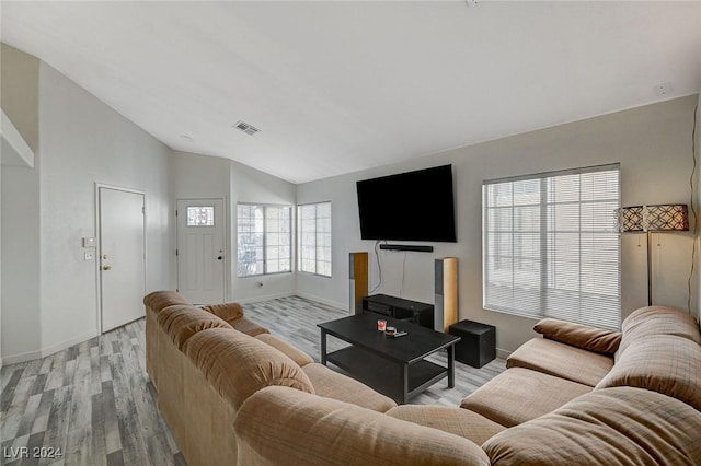 living room with light hardwood / wood-style floors and lofted ceiling