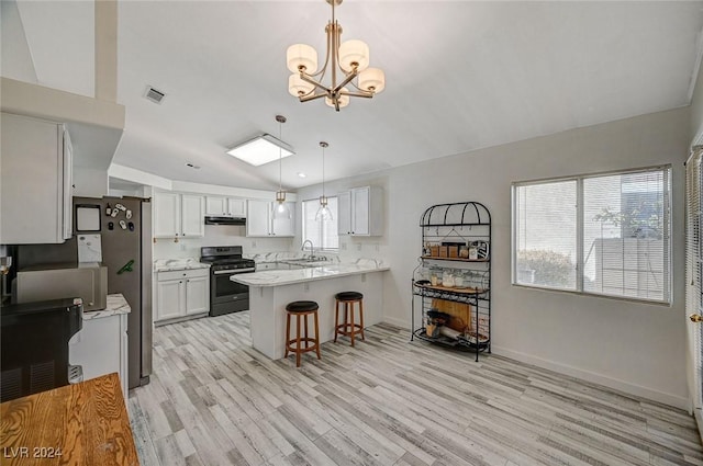 kitchen featuring sink, decorative light fixtures, a kitchen bar, white cabinets, and appliances with stainless steel finishes