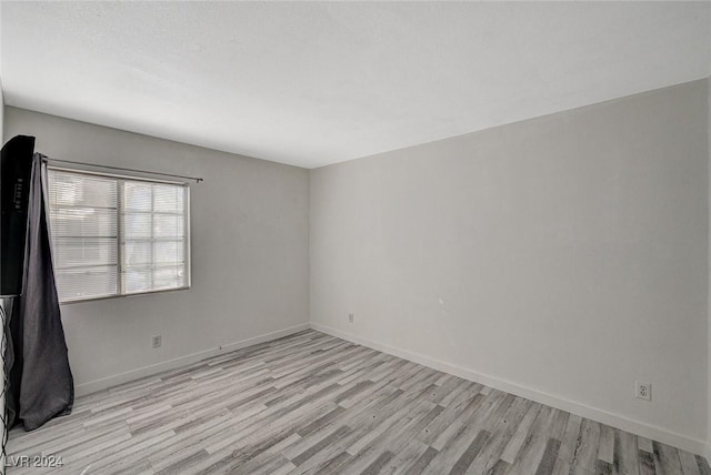 empty room with light hardwood / wood-style floors