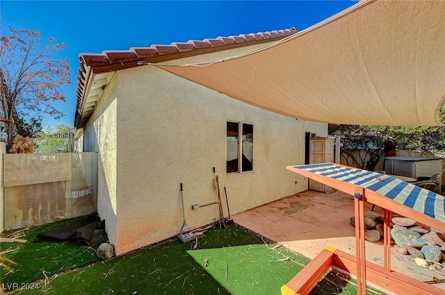 view of side of home featuring a patio