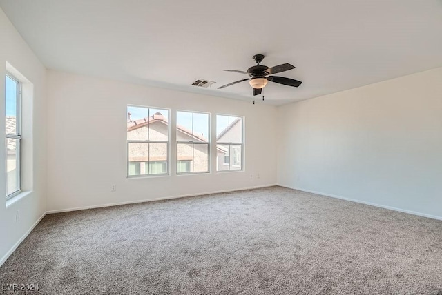 spare room with carpet floors and ceiling fan