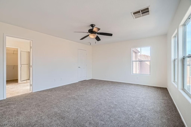 unfurnished room with ceiling fan and light carpet