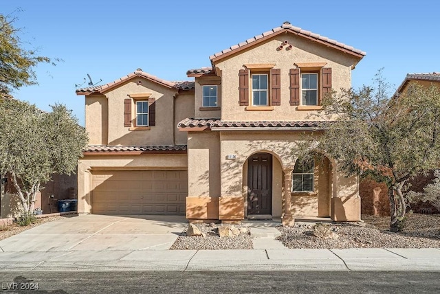 mediterranean / spanish-style home featuring a garage