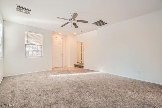 empty room with light carpet and ceiling fan