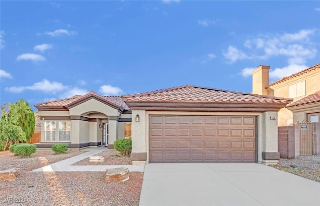 mediterranean / spanish-style house with a garage