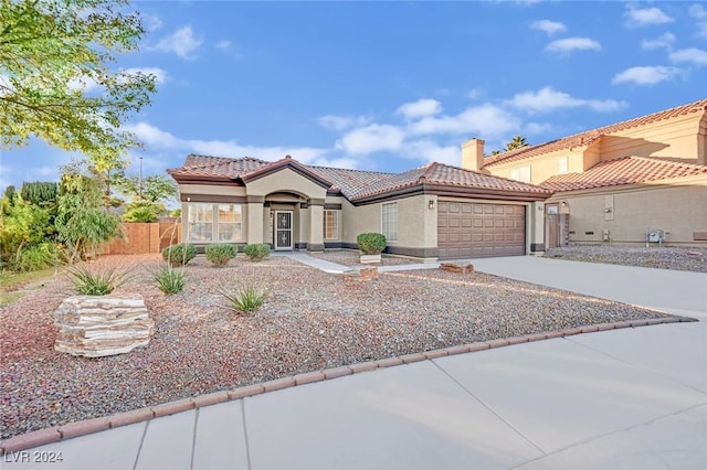 mediterranean / spanish-style home featuring a garage