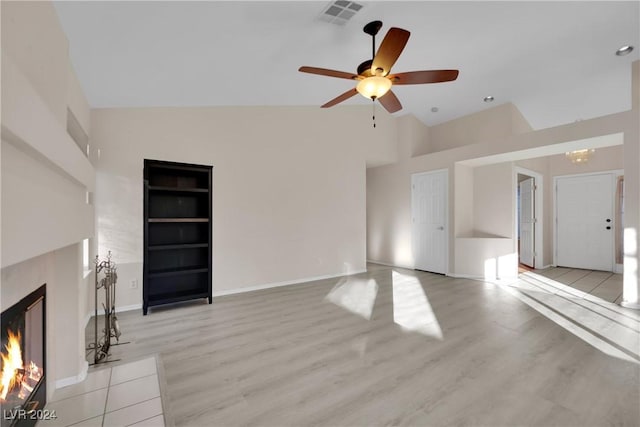 unfurnished living room featuring built in shelves, high vaulted ceiling, light hardwood / wood-style flooring, and ceiling fan