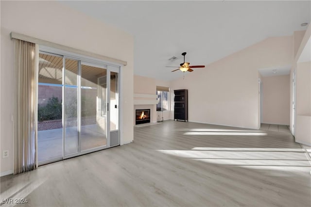 unfurnished living room featuring light hardwood / wood-style flooring, vaulted ceiling, and ceiling fan