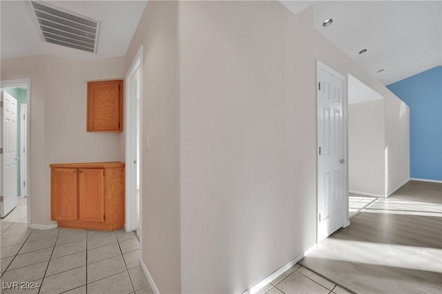 corridor featuring light tile patterned flooring