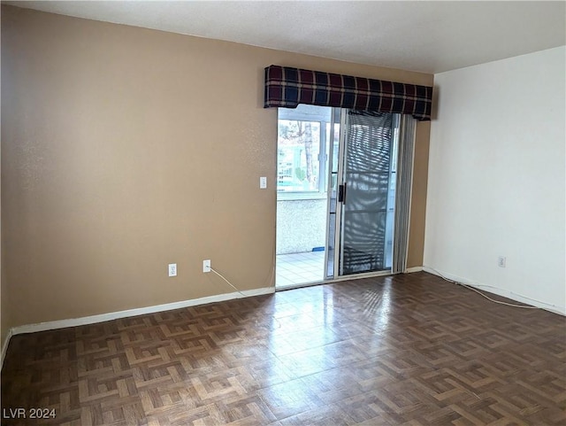 unfurnished room featuring dark parquet flooring