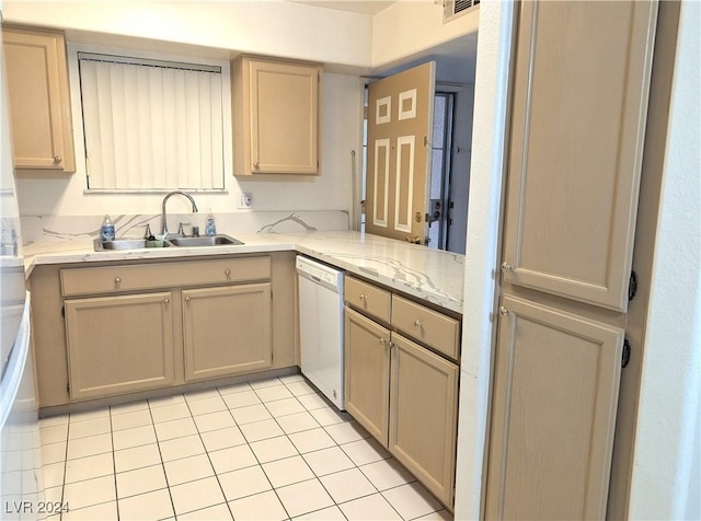 kitchen with white dishwasher, light brown cabinets, light tile patterned floors, and sink