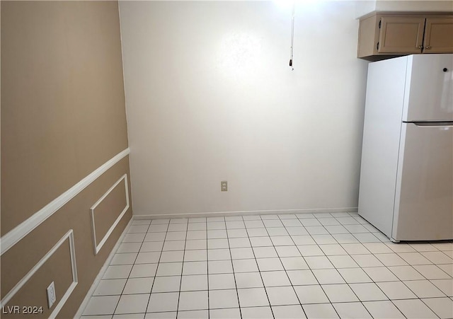 kitchen with white fridge and light tile patterned floors