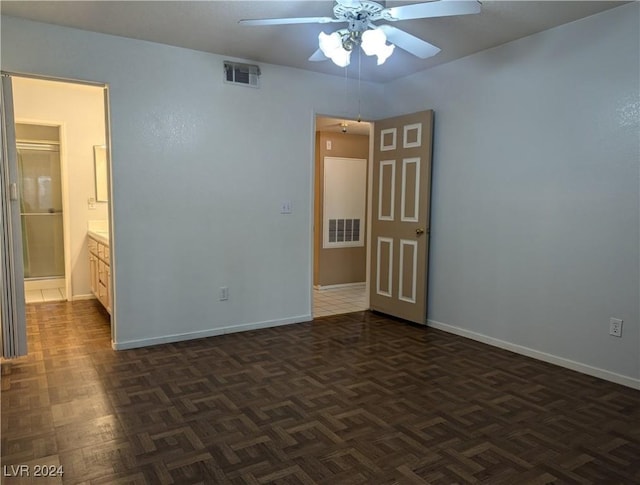 spare room with dark parquet flooring and ceiling fan