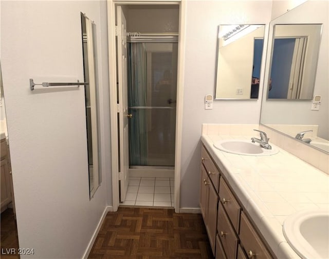 bathroom with walk in shower, vanity, and parquet floors