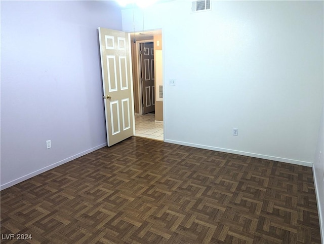 unfurnished room with dark parquet floors