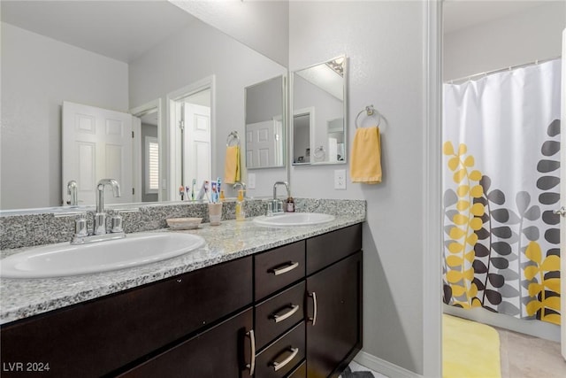 bathroom featuring vanity and a shower with shower curtain