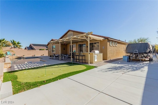 back of property featuring a pergola, a patio area, area for grilling, and a pool