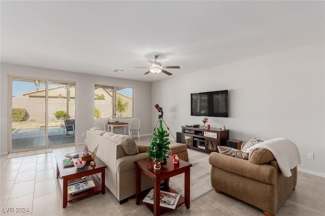 living room featuring a wealth of natural light and ceiling fan