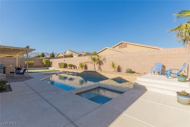 view of swimming pool with an in ground hot tub and a patio