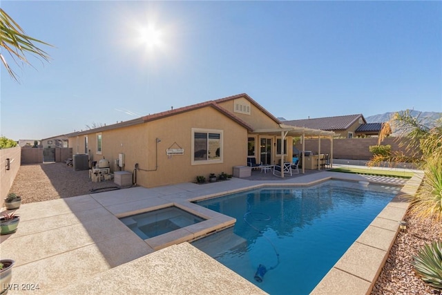 view of swimming pool with a patio area and an in ground hot tub