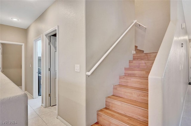 stairs featuring tile patterned floors