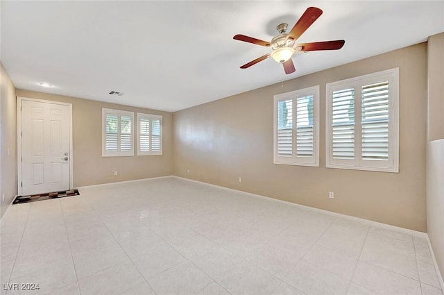 spare room featuring a wealth of natural light and ceiling fan