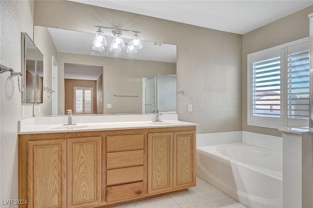 bathroom featuring tile patterned flooring, vanity, and a bath