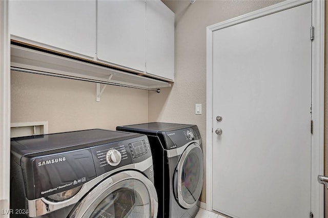 laundry area with cabinets and washing machine and clothes dryer