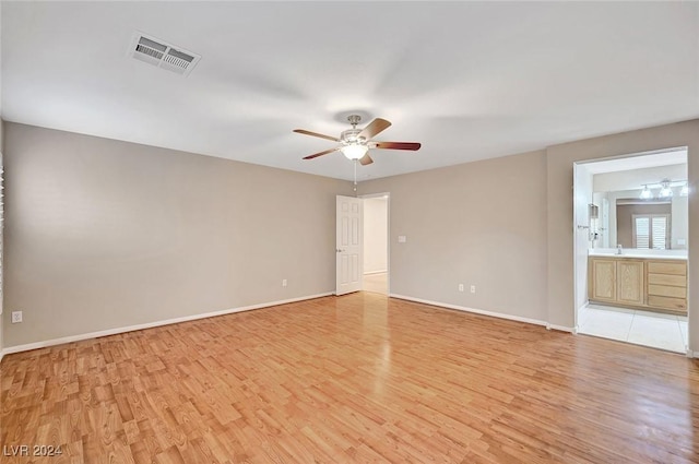 empty room featuring ceiling fan and light wood-type flooring