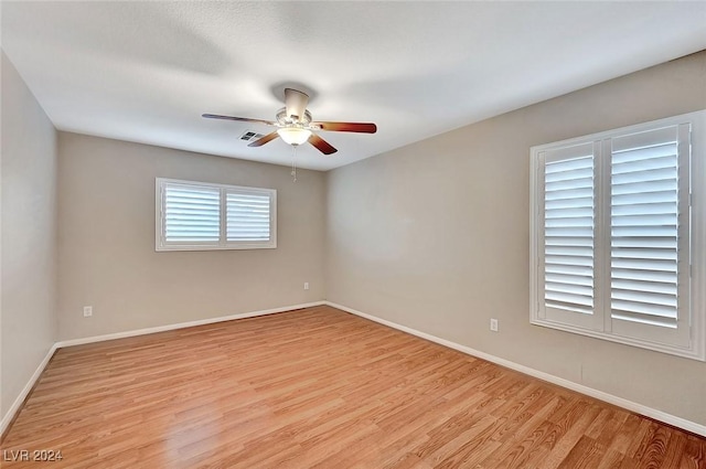 unfurnished room featuring light hardwood / wood-style flooring and ceiling fan