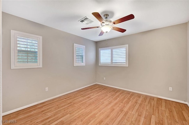 spare room featuring ceiling fan and light hardwood / wood-style flooring